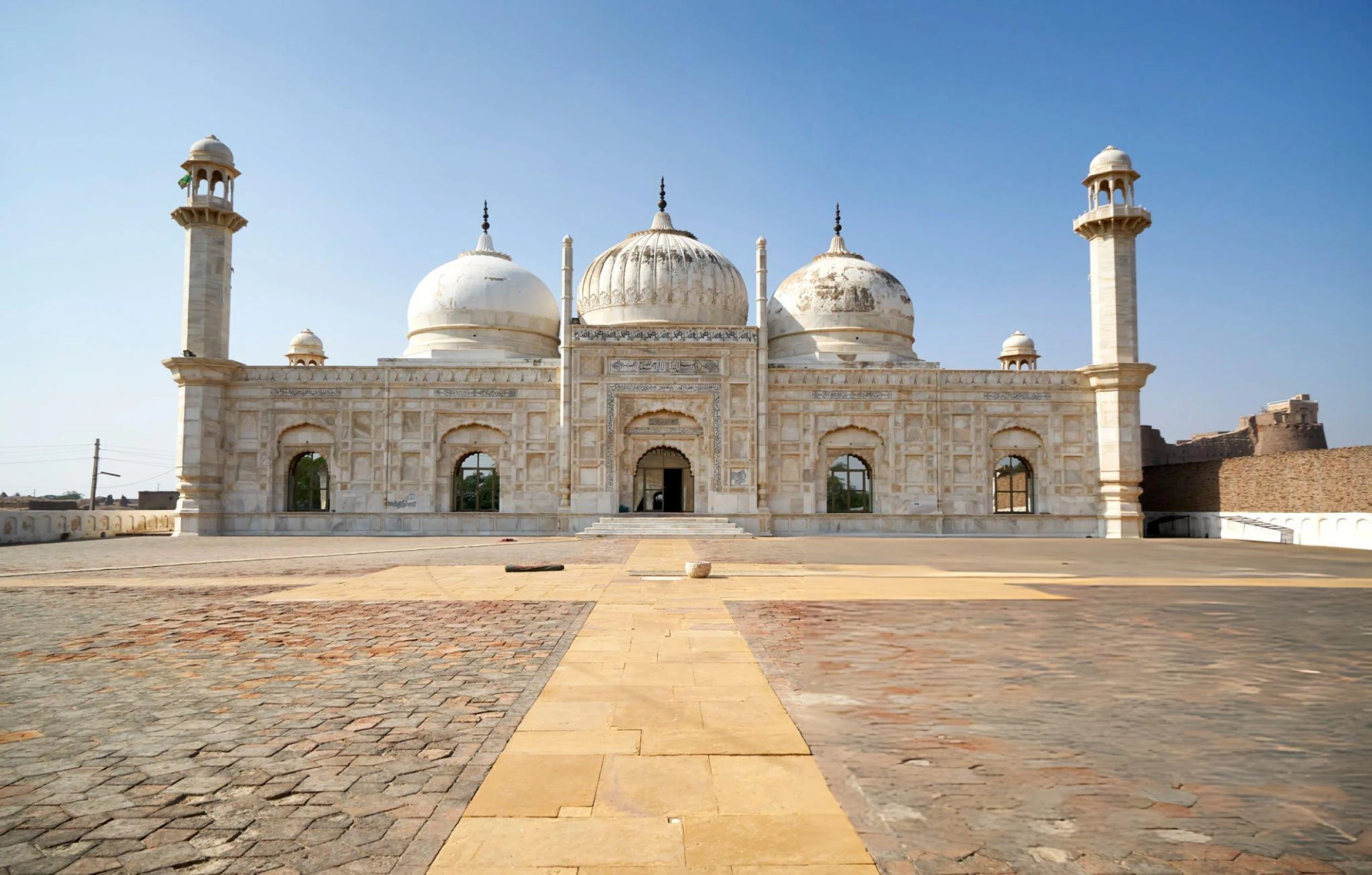Detail of the Abbasi Mosque facade showing marble calligraphy and arched entrance